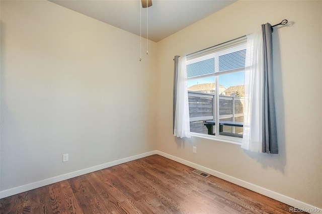 empty room with ceiling fan and hardwood / wood-style flooring