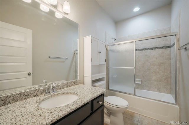 full bathroom with toilet, bath / shower combo with glass door, tile patterned floors, and vanity