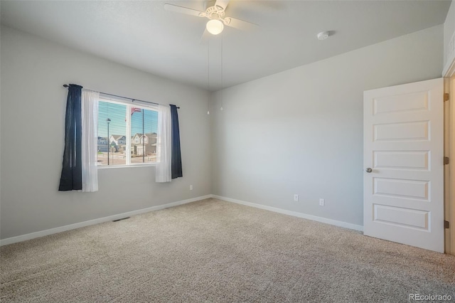 carpeted empty room featuring ceiling fan