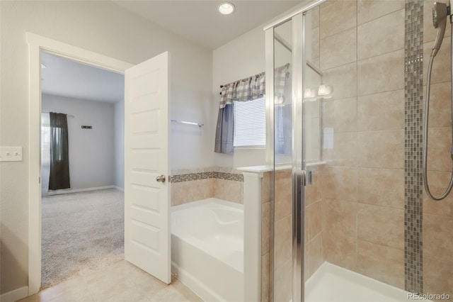 bathroom featuring tile patterned floors and shower with separate bathtub