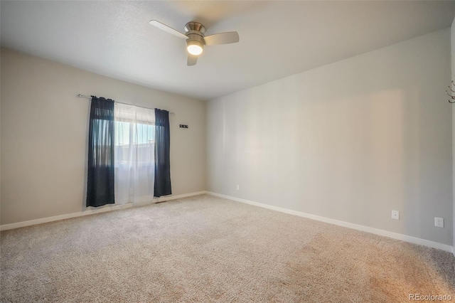 empty room with ceiling fan and carpet