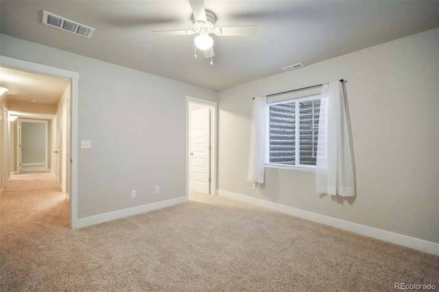 carpeted spare room with ceiling fan