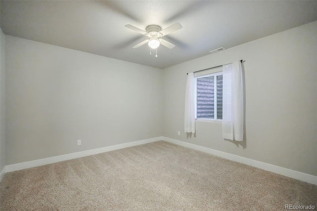 carpeted spare room with ceiling fan