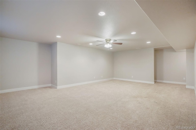 empty room with ceiling fan and light carpet