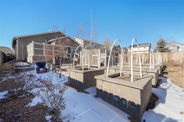 view of snow covered rear of property