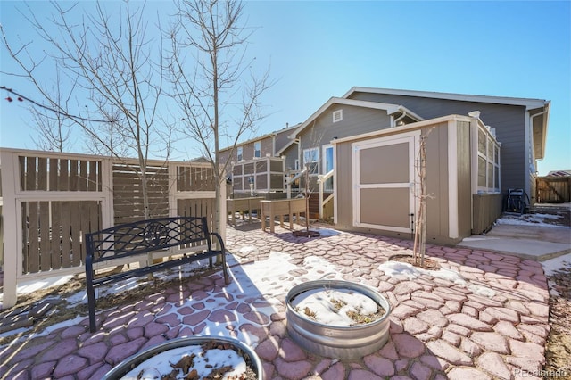 view of patio / terrace with an outdoor fire pit and a shed