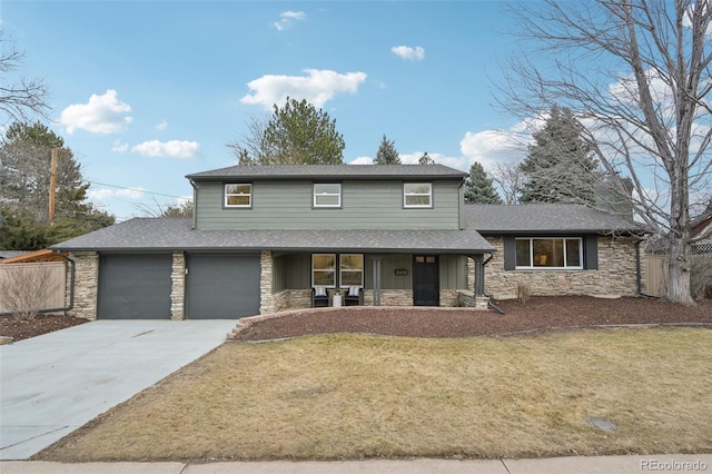 view of front of property featuring stone siding, covered porch, fence, and a front lawn