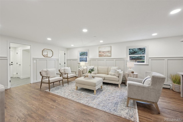 living room with a wainscoted wall, a baseboard radiator, wood finished floors, baseboard heating, and recessed lighting