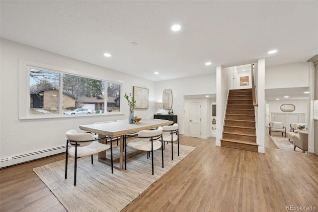 dining room featuring stairs, a baseboard heating unit, light wood-type flooring, and recessed lighting