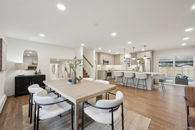 dining space with stairs, wood finished floors, and recessed lighting