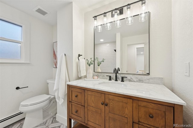 bathroom with toilet, baseboard heating, vanity, and visible vents