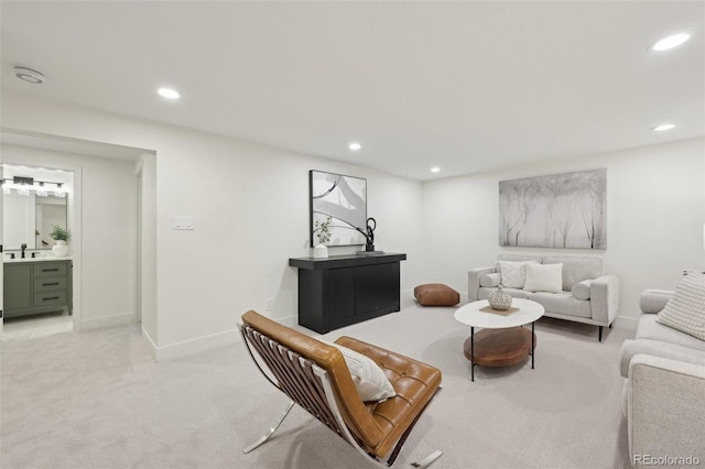 living area with recessed lighting, light colored carpet, and baseboards