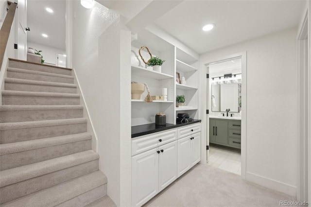 interior space featuring baseboards, built in shelves, carpet, and recessed lighting