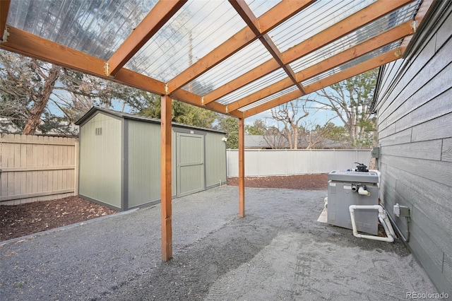 view of patio / terrace featuring a storage shed, an outdoor structure, a fenced backyard, and a pergola