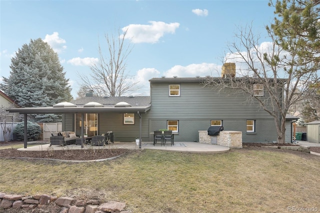 back of house with outdoor lounge area, fence, a yard, a chimney, and a patio area