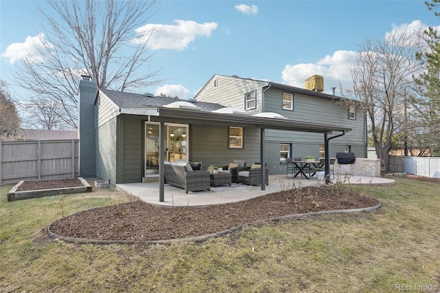 rear view of property with a patio area, outdoor lounge area, a yard, and a chimney