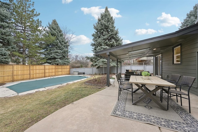 view of patio / terrace featuring a fenced in pool, outdoor dining area, and a fenced backyard