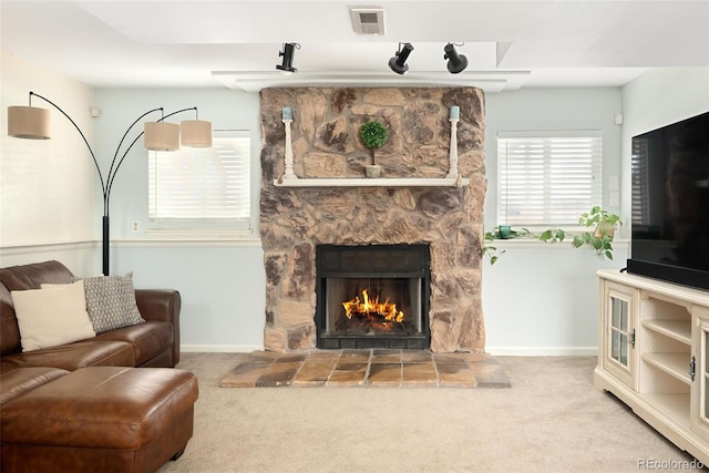 carpeted living room featuring a fireplace