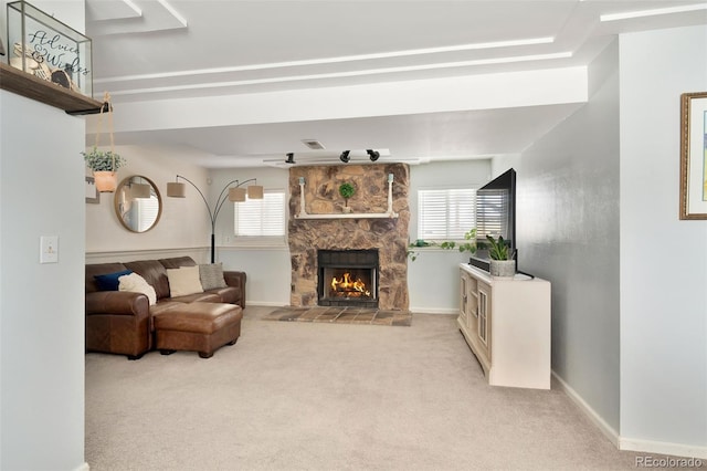 carpeted living room featuring a healthy amount of sunlight and a fireplace