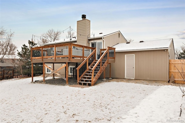 snow covered property with a wooden deck