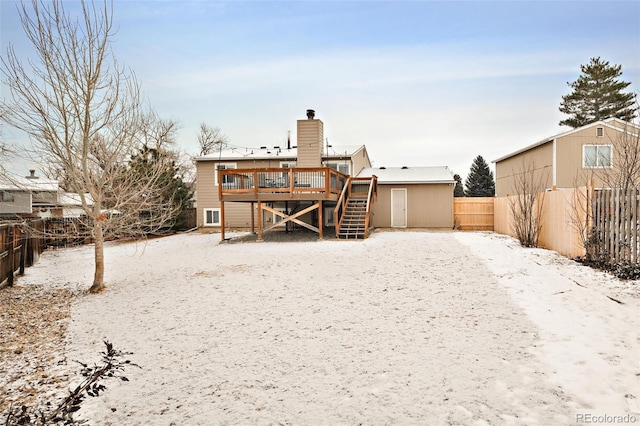 snow covered house with a deck