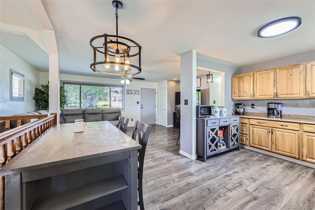 1166 W 98th Ave, Northglenn, CO 80260 - kitchen featuring light brown cabinetry, open floor plan, open shelves, and light countertops