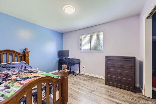 1166 W 98th Ave, Northglenn, CO 80260 - bedroom with baseboards and light wood-type flooring