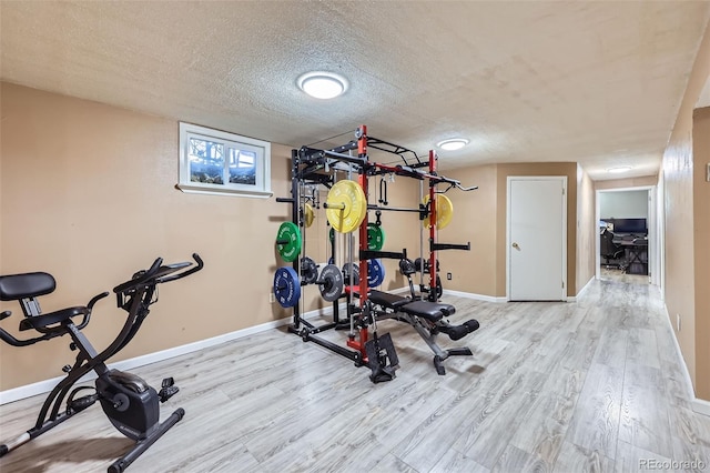 1166 W 98th Ave, Northglenn, CO 80260 - exercise room with wood finished floors and a textured ceiling