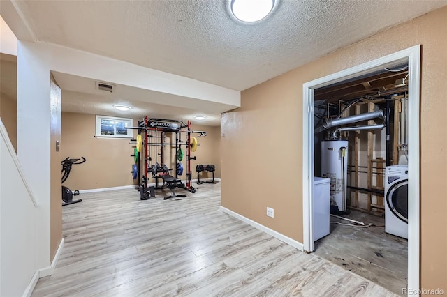 1166 W 98th Ave, Northglenn, CO 80260 - workout area featuring water heater, washer / dryer, a textured ceiling, and wood finished floors