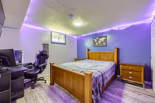 1166 W 98th Ave, Northglenn, CO 80260 - bedroom with wood finished floors, a textured ceiling, and a desk