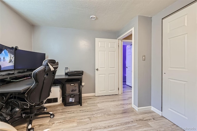 1166 W 98th Ave, Northglenn, CO 80260 - home office with light wood-style flooring and a textured ceiling