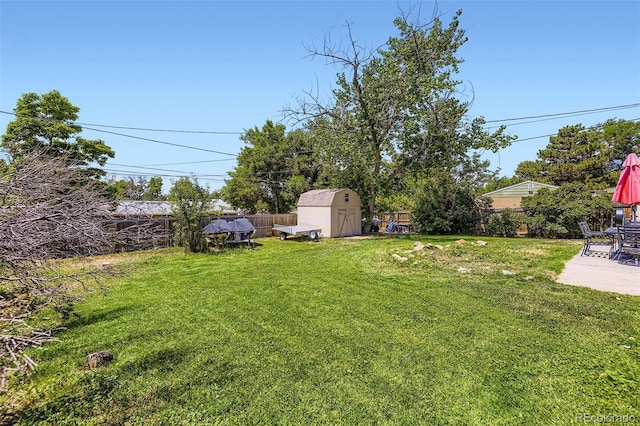 1166 W 98th Ave, Northglenn, CO 80260 - fenced backyard with a storage shed and a patio area