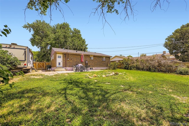 1166 W 98th Ave, Northglenn, CO 80260 - fenced backyard featuring a patio area and entry steps