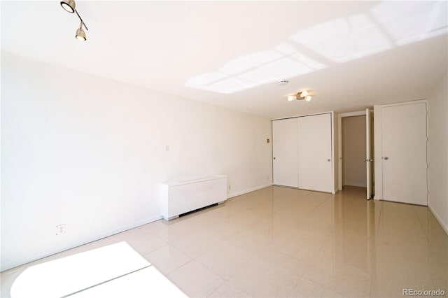 spare room featuring light tile patterned flooring