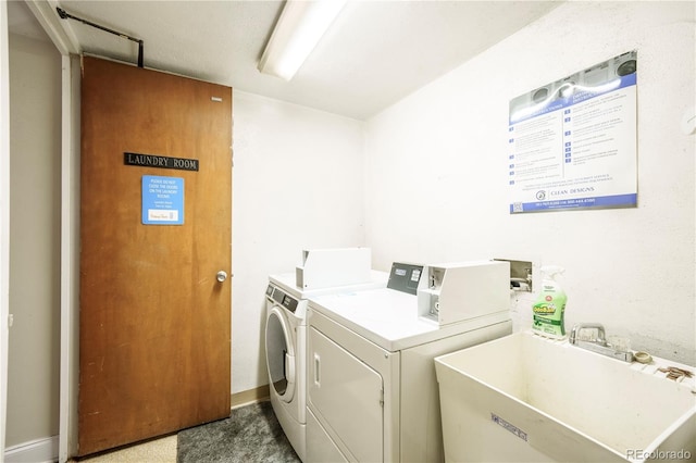 laundry room with separate washer and dryer and sink