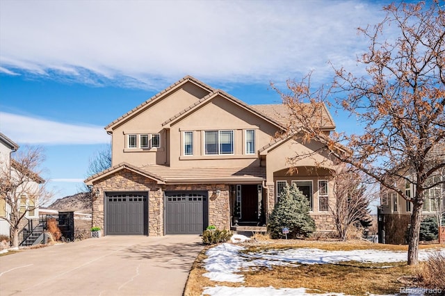 view of front of home featuring a garage, stone siding, concrete driveway, a tiled roof, and stucco siding