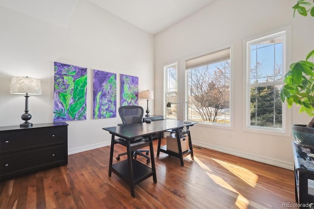 home office featuring dark wood-type flooring and baseboards