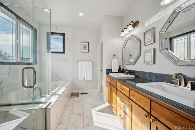 full bath with double vanity, a marble finish shower, marble finish floor, a garden tub, and a sink