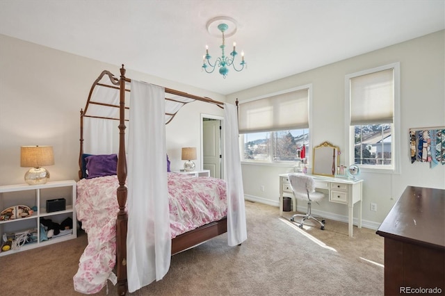 bedroom with a chandelier, carpet floors, and baseboards