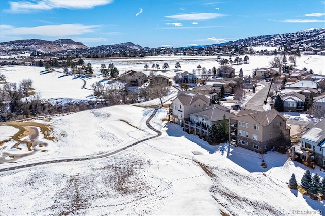 snowy aerial view with a residential view and a mountain view