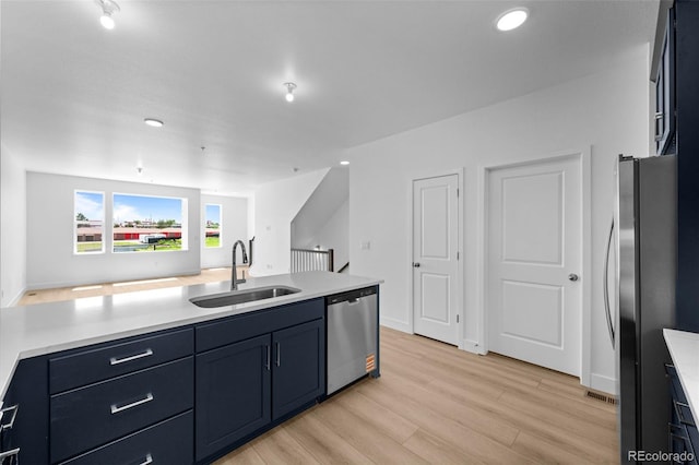 2740 W 68th Ave, Denver, CO 80221 - kitchen with stainless steel appliances, light countertops, light wood finished floors, recessed lighting, and open floor plan
