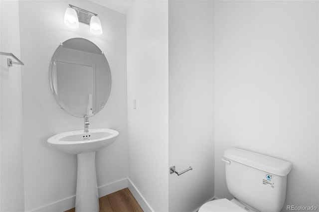 2740 W 68th Ave, Denver, CO 80221 - half bathroom featuring toilet and wood finished floors