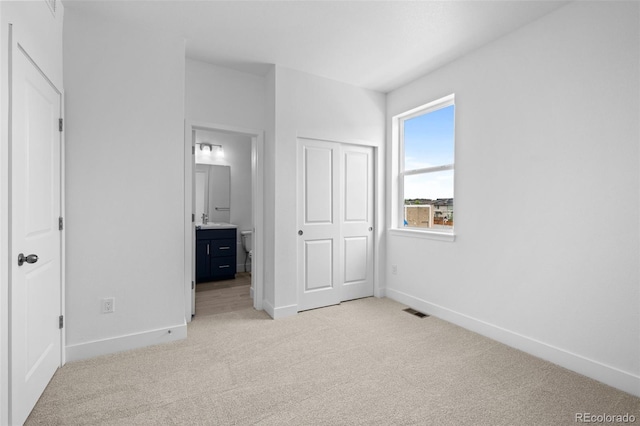 2740 W 68th Ave, Denver, CO 80221 - unfurnished bedroom featuring light colored carpet, connected bathroom, and a closet