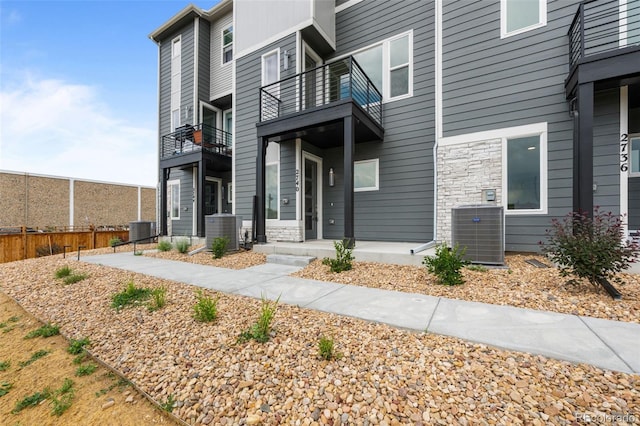 2740 W 68th Ave, Denver, CO 80221 - property entrance featuring a balcony and stone siding