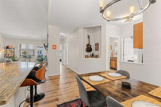 dining room featuring a notable chandelier and light wood finished floors