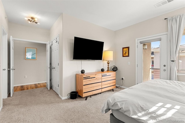 bedroom with baseboards, multiple windows, light colored carpet, and visible vents