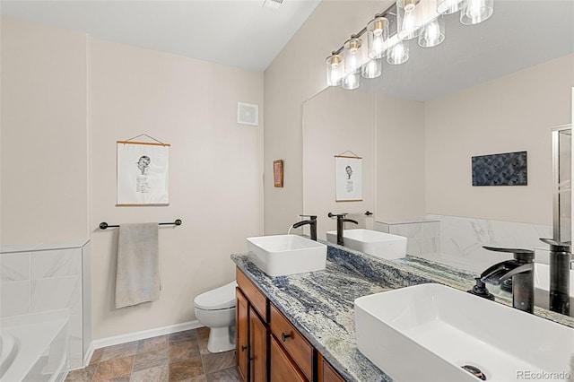bathroom with toilet, baseboards, and a sink