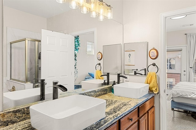 ensuite bathroom featuring a sink, a shower stall, connected bathroom, and visible vents