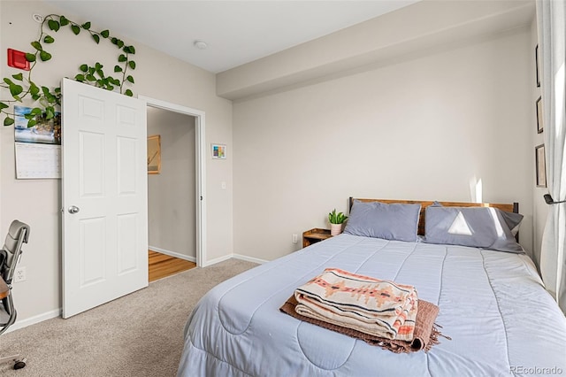 bedroom with baseboards and carpet