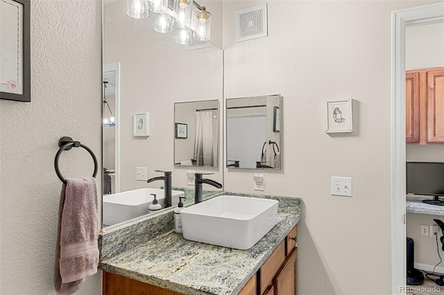 bathroom with vanity and visible vents